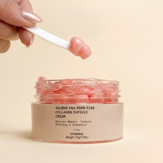 : Salmon DNA PDRN Pink Collagen Cream texture — pink capsules with spatula